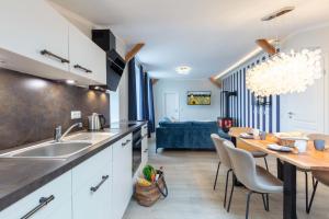 a kitchen with a table and a dining room at Osterhof Fehmarn - Casa Mare in Fehmarn
