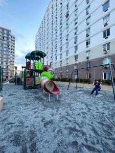 two children playing on a playground in a city at CityView Near Airport with Pool&Balcony in Lapu Lapu City