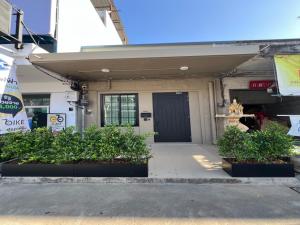 a front door of a building with plants in front at Sri House at Supasarnrangsan in Hat Yai