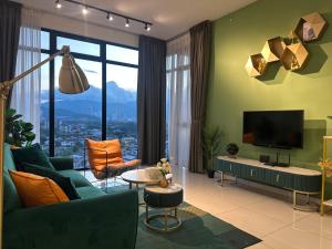 a living room with a couch and a tv at New 2BR Georgetown Warm and Lovely Homestay 10pax-无敌美景两房民宿 Beacon Executive Suite in George Town