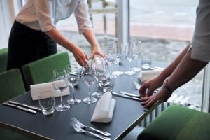 a table with wine glasses on top of it at Hotel Red & Green in Närpiö