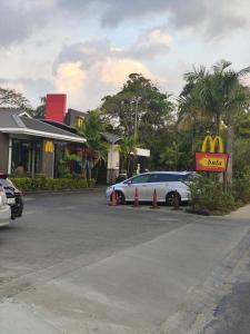 a car parked in a parking lot with a mcdonalds sign at Alice Luxury Apartments near Nadi McDonald's in Nadi