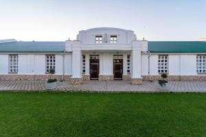 a large white house with a green roof at Togryersvlei Venue & Guest House in Jacobs Bay