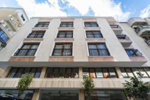 a tall building with many windows on it at MB City Hotel in İzmir