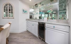 a bathroom with two sinks and a large mirror at Phoenix on the Bay 1513 condo in Orange Beach