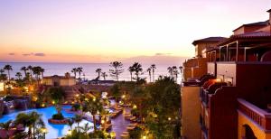 a view of a resort with a pool and the ocean at Europe Villa Cortes GL in Playa de las Americas