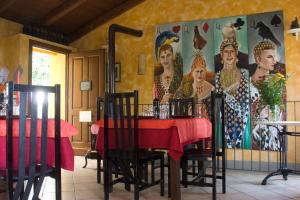 a dining room with a table and a painting on the wall at Arco Dei Nobili in Monforte dʼAlba