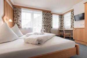 Postel nebo postele na pokoji v ubytování SCHMID Rooms & Apartments