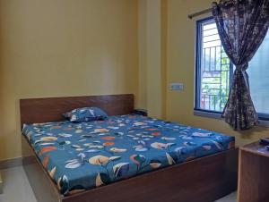 Postel nebo postele na pokoji v ubytování Rukmini Guest House