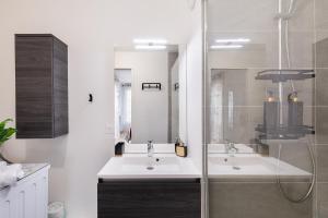 a bathroom with two sinks and a shower at Chic & Cozy Living - Near Heart of Paris in Clichy +22 photos