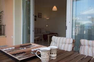 a living room with a wooden table with two chairs at Dream Vacation Apartment in Acharavi