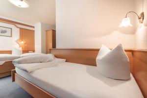 Postel nebo postele na pokoji v ubytování SCHMID Rooms & Apartments