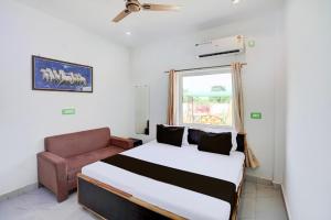 a bedroom with a bed and a couch at Hotel krishna manu place in Orchha