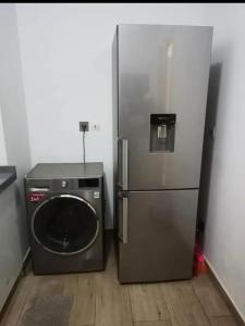 a refrigerator and a washing machine in a room at Appartement de luxe à louer in Dakar