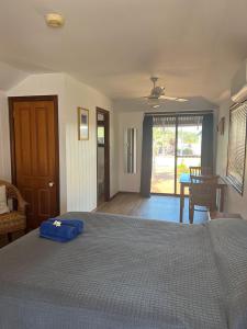 a bedroom with a bed with a blue bag on it at Broome Vacation Village in Broome