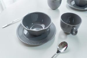 a table with two cups and plates and a spoon at Ruygo Setagaya by Tranova in Tokyo