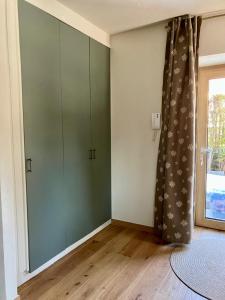 a room with green cabinets and a window at Artemisia in Bardonecchia +3 photos