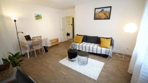 a living room with a couch and a table at Appartement bien-être Issoire in Issoire