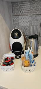 a counter with two containers of food and a toaster at Villa Flora di Capriata d'orba in Predosa