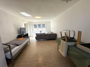 a living room with two beds and a couch at Großes 2-Zimmer Apartment mit TV, Wifi in Oerlinghausen