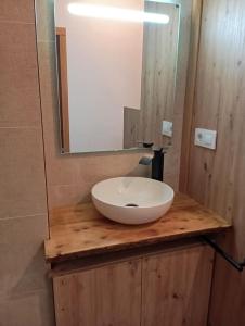 a bathroom with a white sink on a wooden counter at Atico maravilloso en Cangas , Vigo in Cangas de Morrazo