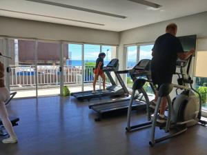 a group of people exercising on treadmills in a gym at Mike's Place at Marina Spatial in Dumaguete