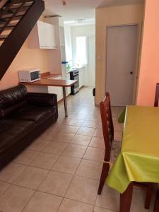 a living room with a couch and a table at Casas Amobladas y Equipadas Calama in Calama +10 photos