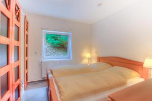a bedroom with a bed and a window at Windeby 1T in Wenningstedt +17 photos