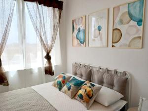 a bedroom with a bed with two pillows and a window at BlueCharme modern apartment in Quartu SantʼElena