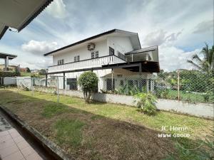 a white house with a fence in front of it at Kempas Kampung style 12pax Family Suites in Johor Bahru