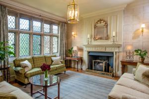 a living room with a couch and a fireplace at Amberley Castle- A Relais & Chateaux Hotel in Amberley