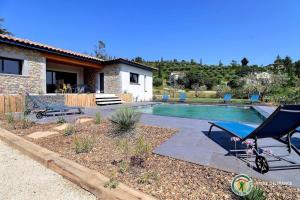 a house with a swimming pool in front of a house at Villa la crozette 4 étoiles, climatisée avec grande piscine in Ruoms