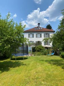 a large white house with a bench in the yard at Haus mit Geschichte in Mähring in Mähring