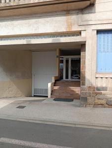 an entrance to a building with a garage at Appartement bien-être Issoire in Issoire