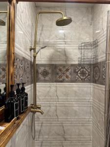 a shower in a bathroom with a shower head at Machanents Art Hotel in Vagharshapat