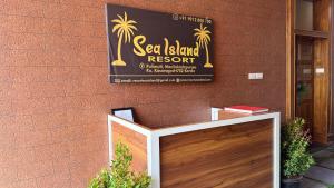 a sign for a seafood restaurant on the side of a building at Sea Island Resort in Cheruvattūr