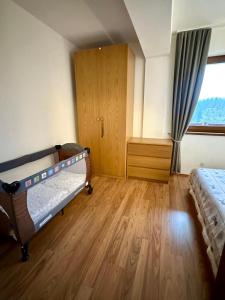 a bedroom with two bunk beds and a window at Apartman Kamzik Teo in Donovaly