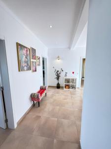 a living room with white walls and a tile floor at Pôr-do-sol Villa in São Pedro do Corval +41 photos