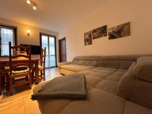 a living room with a couch and a table at Residenza dell'Arco in Gambolò