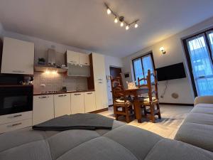 a kitchen and living room with a couch and a table at Residenza dell'Arco in Gambolò +19 photos