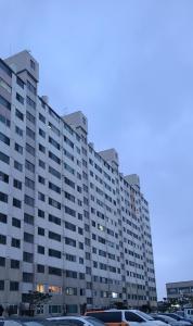 a large building with cars parked in a parking lot at Ssongssong's in Wanju