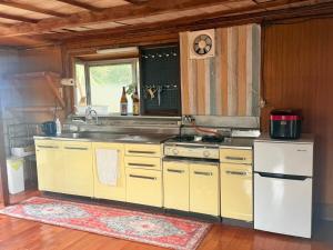 a kitchen with a white refrigerator and a sink at -1日1組限定一棟貸し-坂嶺ふる里庵-大人数におすすめ- in Nishime