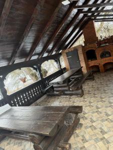a wooden bench sitting inside of a building at Gospodaria Klaus in Rozavlea +21 photos