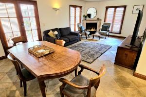 a living room with a table and a couch at Sandstone Suites - In the heart of Port Fairy in Port Fairy