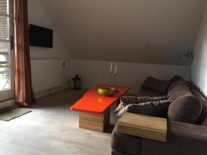 a living room with a couch and a red table at Bagsværd Apartment in Hareskovby