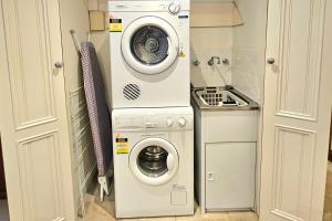 a washer and dryer in a small kitchen at Sandstone Suites - In the heart of Port Fairy in Port Fairy