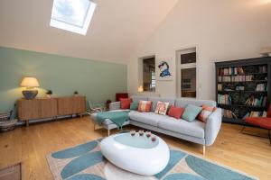 a living room with a couch and a table at Le Clos des Moriers 2 hours from Paris-Piscine-12 pers in Blois