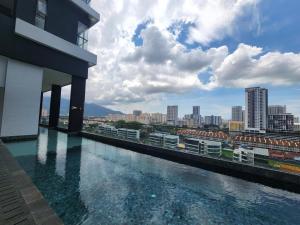a swimming pool on the side of a building at Urban Suites - Queens Suite in Jelutong