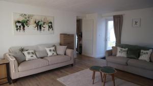a living room with a couch and a table at La Maison Arc-en-ciel in Brigueuil-le-Chantre +24 photos