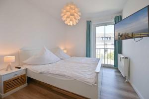 Postel nebo postele na pokoji v ubytování FeWo Rath + 2 fotografie